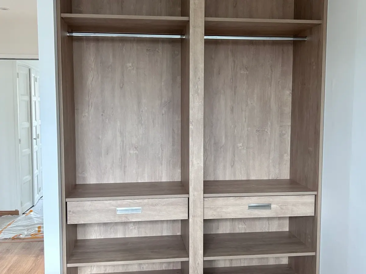 Montage et ajustement minutieux de menuiserie intérieure et placard en bois par un artisan agenceur